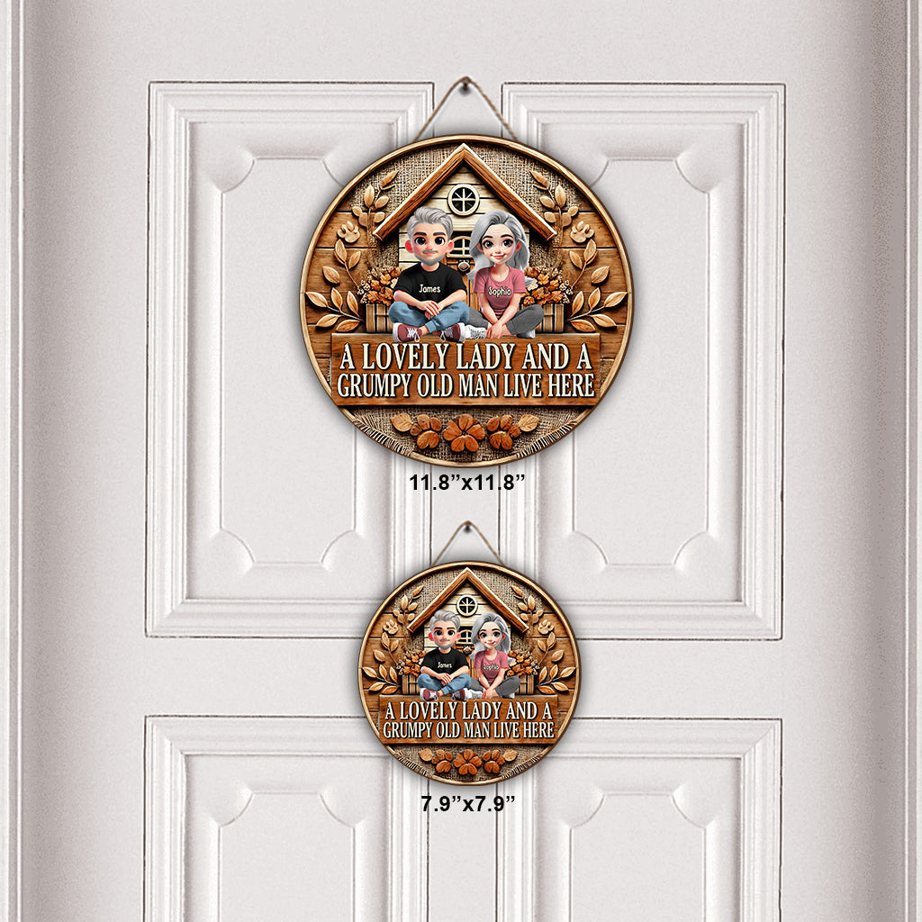 Hier wohnen eine reizende Dame und ein mürrischer alter Mann – personalisiertes rundes Holzschild für Paare